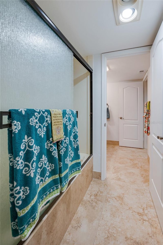 bathroom featuring shower / bath combination with glass door