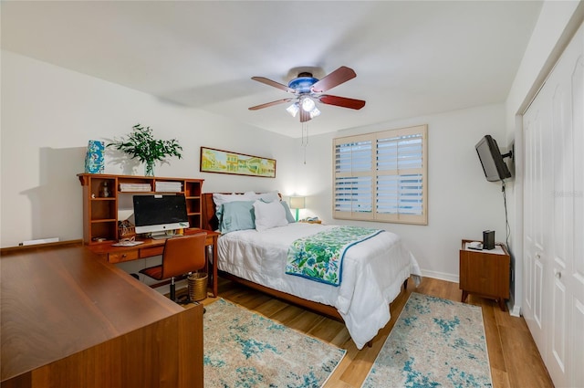 bedroom with light hardwood / wood-style floors, a closet, and ceiling fan