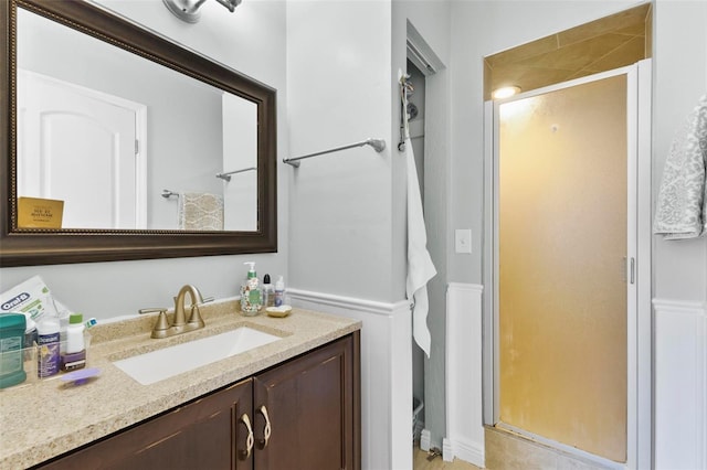 bathroom with vanity and a shower with shower door