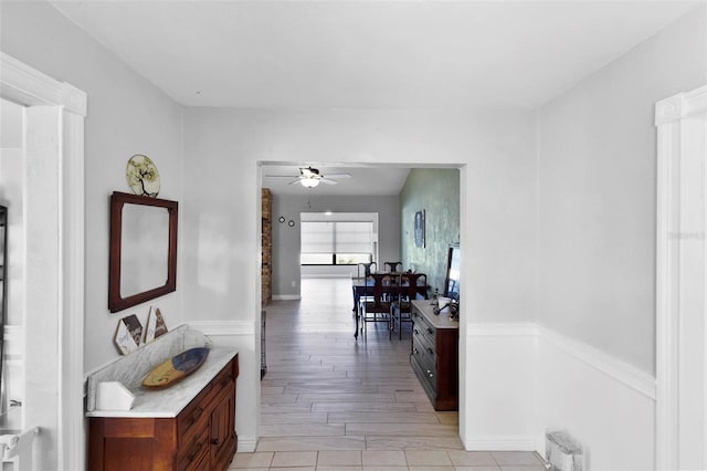 hallway with light hardwood / wood-style floors