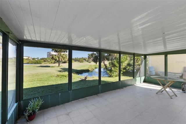 unfurnished sunroom featuring a water view and wood ceiling