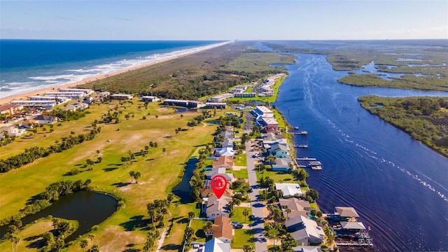 birds eye view of property featuring a water view and a beach view