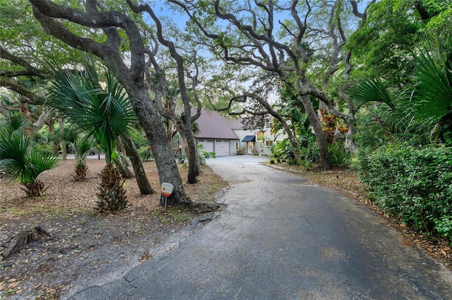 obstructed view of property with a garage