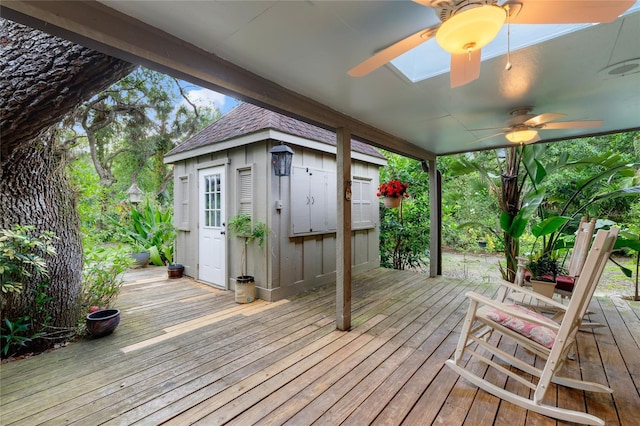 deck featuring an outdoor structure and ceiling fan