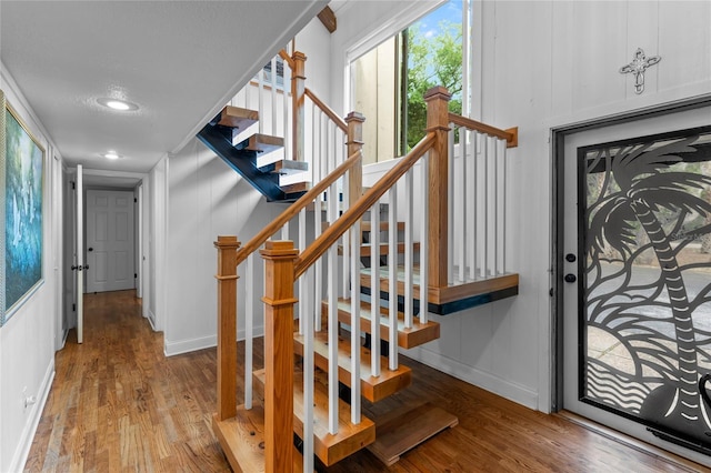 stairs featuring hardwood / wood-style flooring