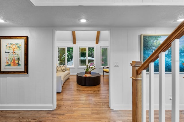 interior space featuring a textured ceiling and light wood-type flooring