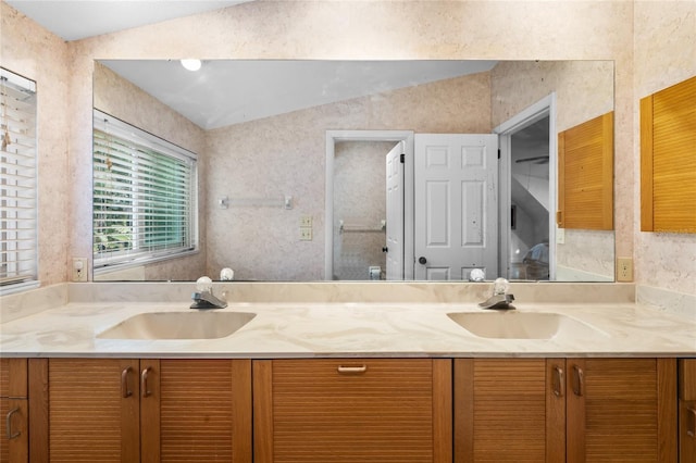 bathroom with vanity and vaulted ceiling