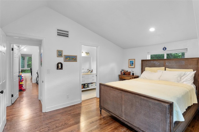 bedroom with lofted ceiling and dark wood-type flooring