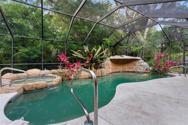 view of pool featuring an in ground hot tub, glass enclosure, and a patio