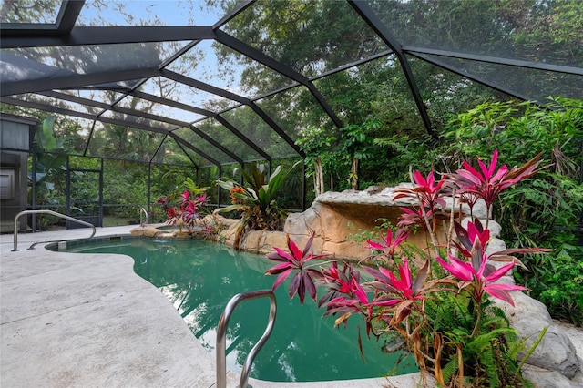 view of pool with a lanai and a patio