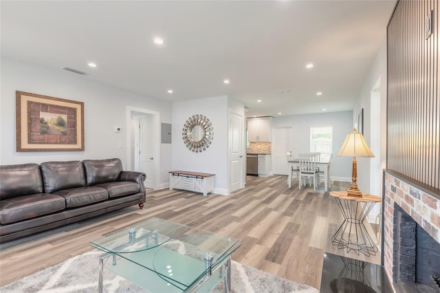 408 Wisteria Rd, Daytona Beach, FL 32118 - living room featuring a fireplace and light wood-type flooring
