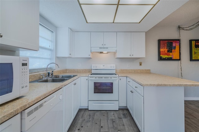 kitchen with white cabinetry, white appliances, light hardwood / wood-style floors, and sink