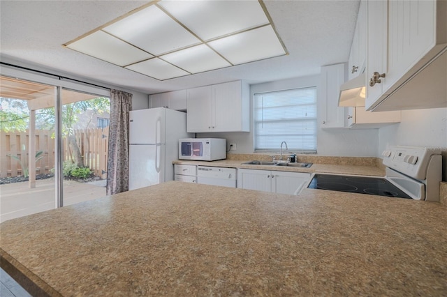 kitchen featuring white appliances, sink, and white cabinets