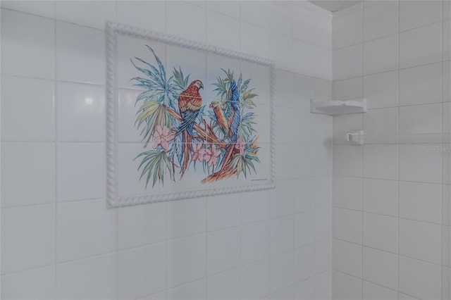 interior details featuring tiled shower