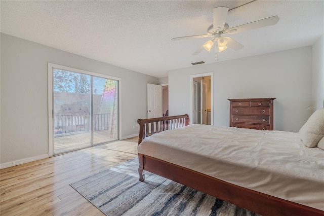 bedroom featuring access to exterior, light hardwood / wood-style flooring, a textured ceiling, and ceiling fan