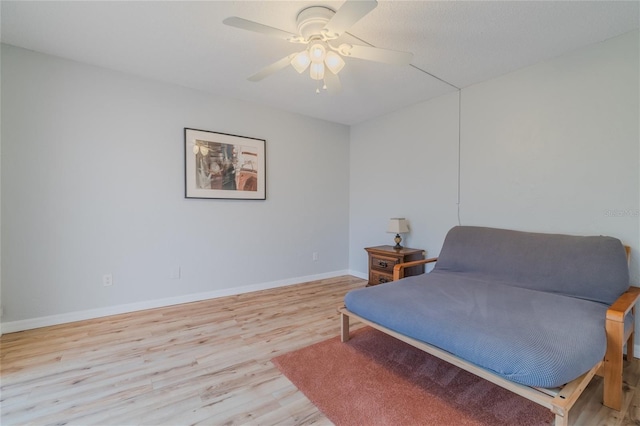 sitting room featuring ceiling fan and light hardwood / wood-style floors