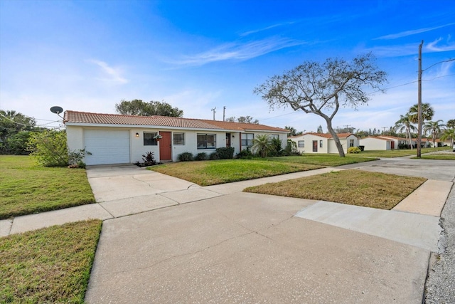 ranch-style house featuring a garage and a front lawn