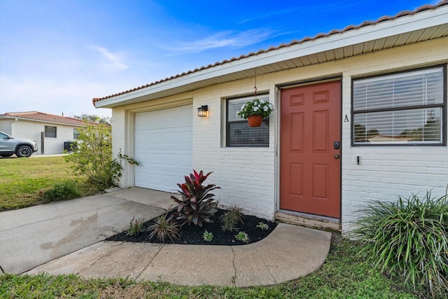 doorway to property with a garage