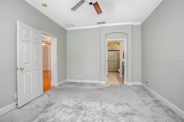 unfurnished bedroom with crown molding, light colored carpet, visible vents, a ceiling fan, and baseboards