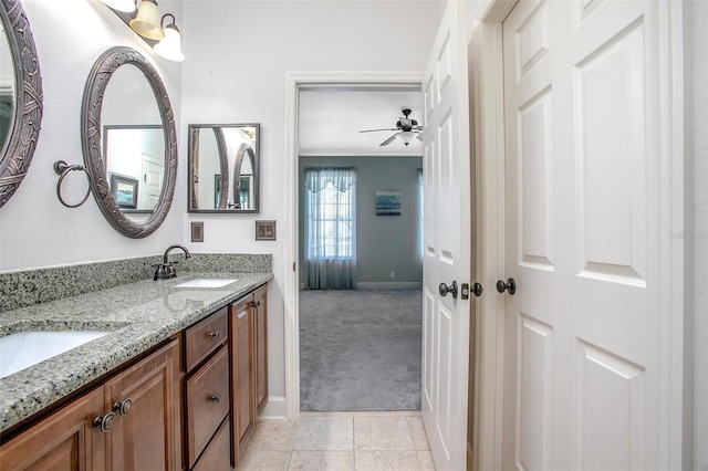 bathroom featuring ceiling fan, double vanity, a sink, and tile patterned floors