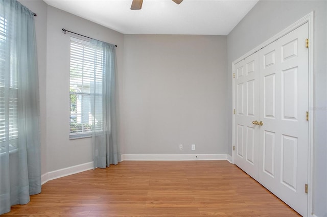 unfurnished bedroom featuring light wood-style floors, ceiling fan, and baseboards