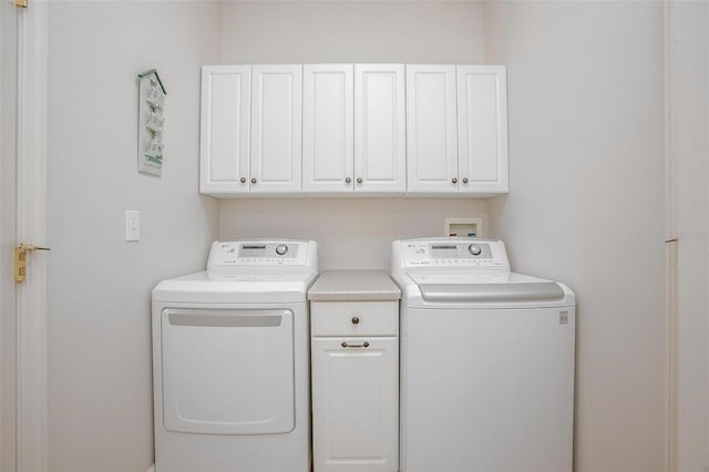 laundry room featuring washer and dryer and cabinet space