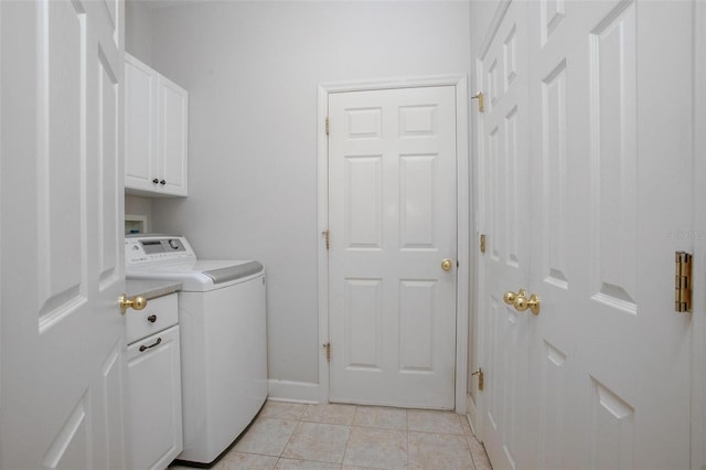 clothes washing area featuring light tile patterned flooring, hookup for a washing machine, cabinet space, and baseboards