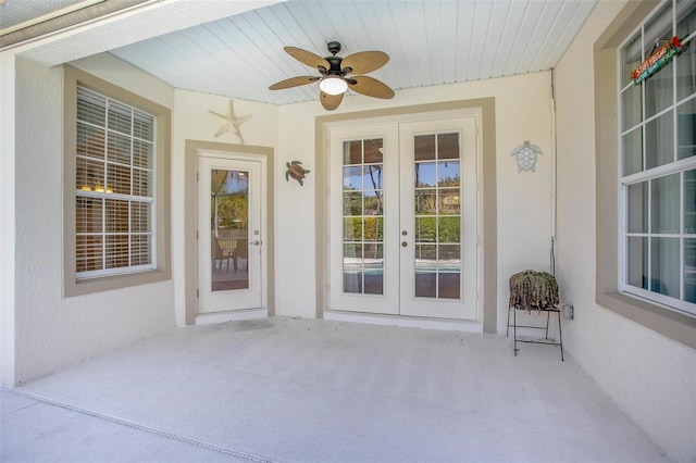 property entrance featuring french doors, a patio area, ceiling fan, and stucco siding