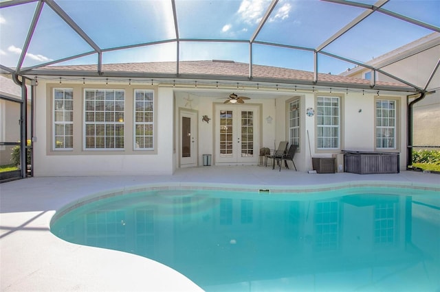 pool featuring a ceiling fan, a patio area, french doors, and glass enclosure