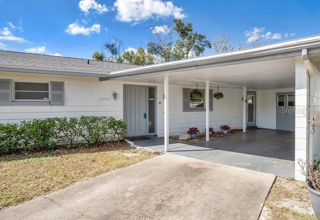 view of exterior entry featuring a carport