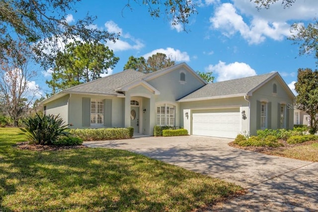 ranch-style house featuring a garage, driveway, a front yard, and stucco siding