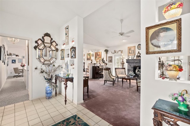 hallway featuring light colored carpet and lofted ceiling