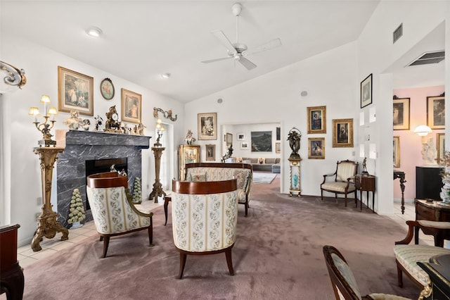 living area featuring a fireplace, high vaulted ceiling, ceiling fan, and carpet