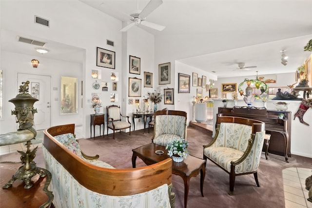 tiled living room with high vaulted ceiling and ceiling fan