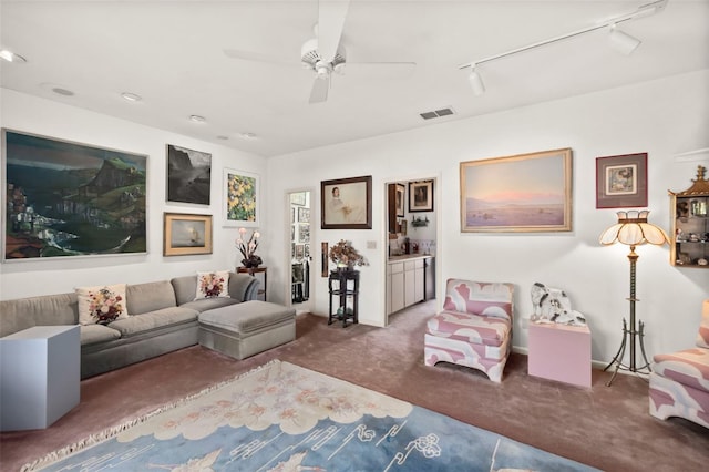 living room with carpet, track lighting, and ceiling fan