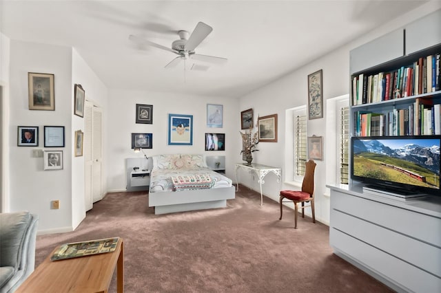 bedroom with ceiling fan, a closet, and dark colored carpet