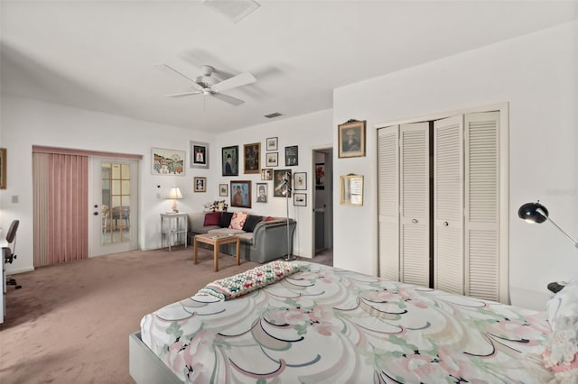 carpeted bedroom with ceiling fan and a closet