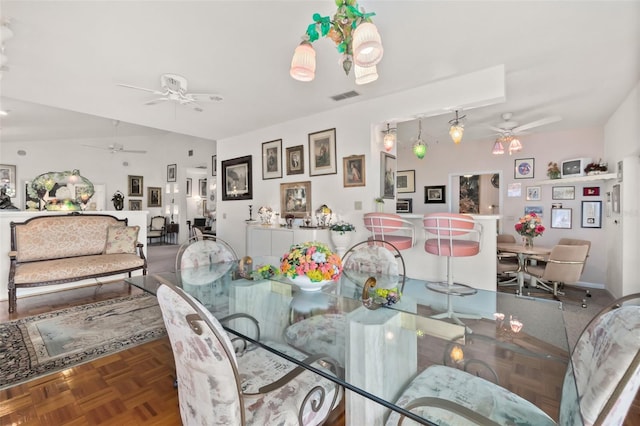 dining space featuring parquet floors and ceiling fan