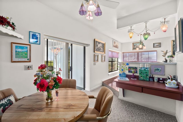 carpeted dining space featuring ceiling fan