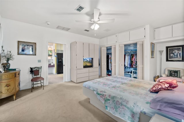 bedroom featuring light colored carpet and ceiling fan