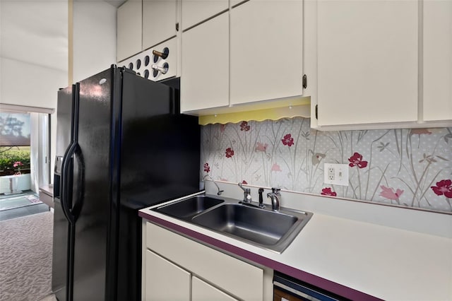 kitchen with sink, carpet, white cabinets, decorative backsplash, and black refrigerator with ice dispenser