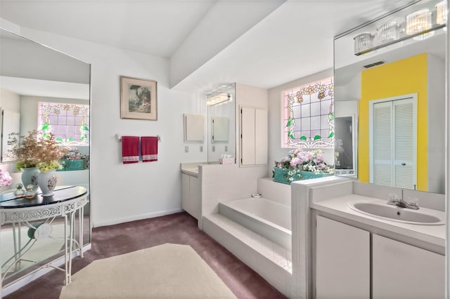 bathroom with vanity and a washtub