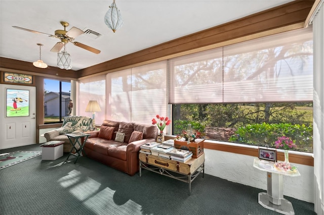 sunroom / solarium with ceiling fan and a healthy amount of sunlight