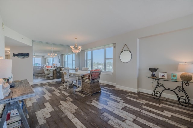 dining area featuring an inviting chandelier and dark hardwood / wood-style flooring