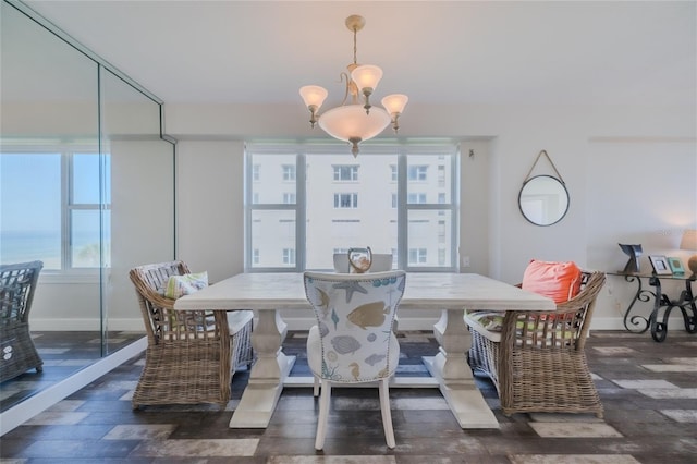 dining room featuring dark wood-type flooring and a notable chandelier