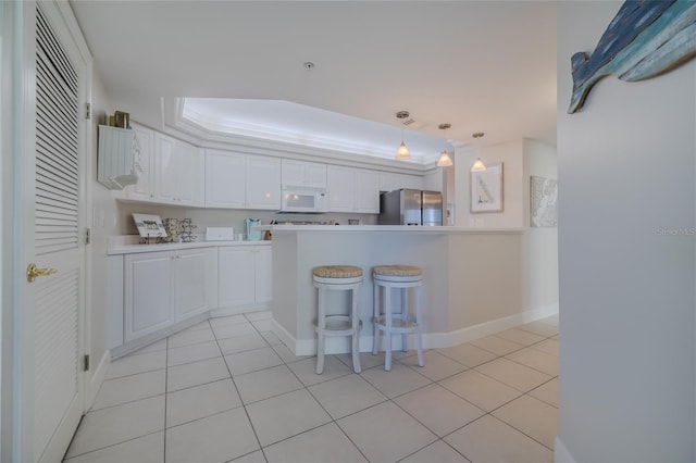 kitchen with white cabinetry, stainless steel fridge with ice dispenser, pendant lighting, and light tile patterned floors