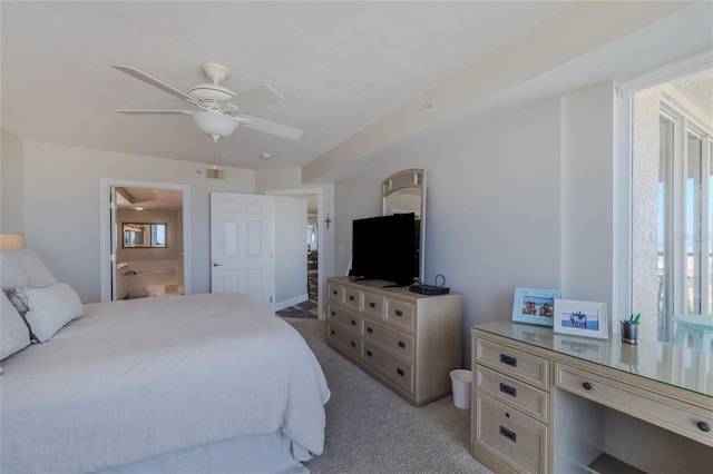 bedroom featuring ceiling fan, light colored carpet, connected bathroom, and multiple windows