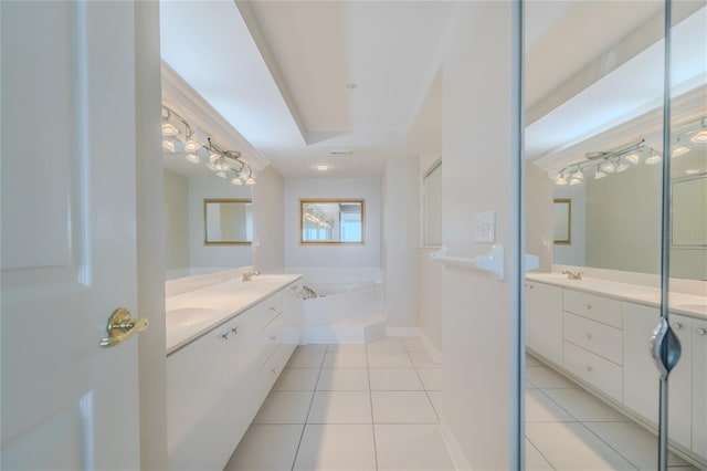 bathroom with tile patterned floors, a bathtub, and vanity