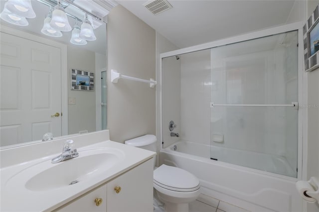 full bathroom featuring vanity, combined bath / shower with glass door, tile patterned floors, and toilet