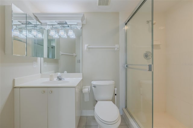 bathroom with toilet, vanity, and a shower with shower door